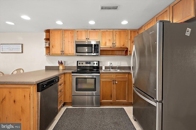 kitchen with kitchen peninsula, light tile patterned floors, stainless steel appliances, and sink