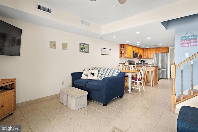 living room with light tile patterned floors and ceiling fan