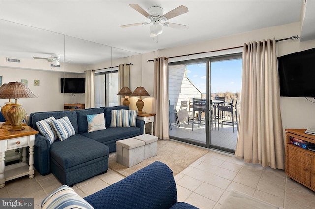 living room with light tile patterned floors and ceiling fan