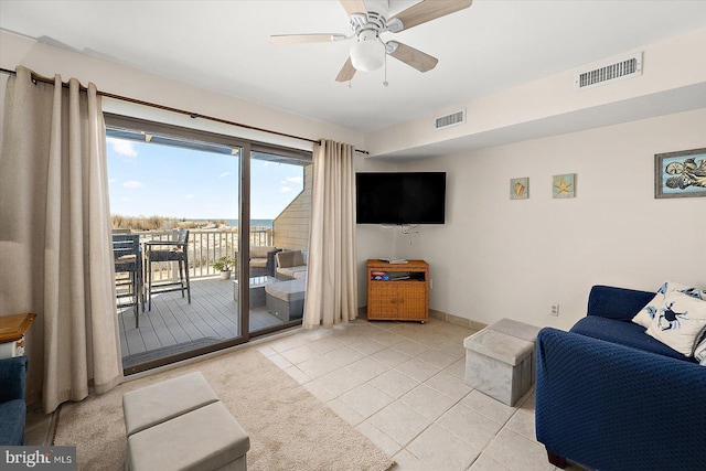 tiled living room with ceiling fan