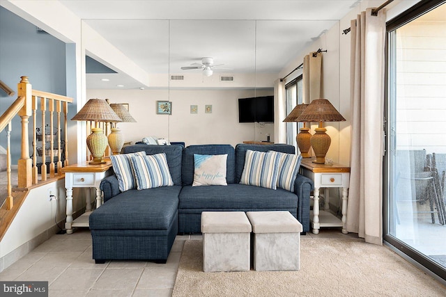 tiled living room with ceiling fan and a wealth of natural light