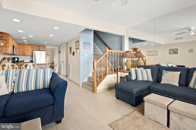 living room featuring ceiling fan and light tile patterned floors