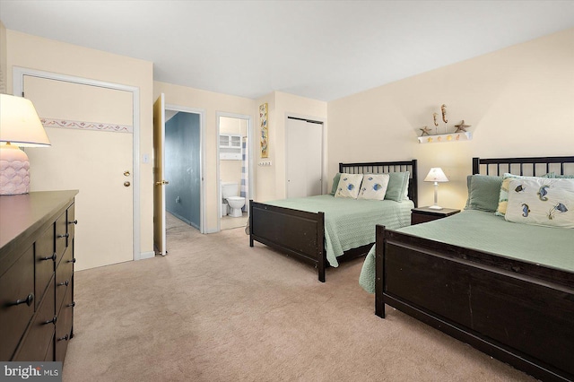 carpeted bedroom featuring connected bathroom