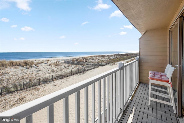 balcony with a beach view and a water view