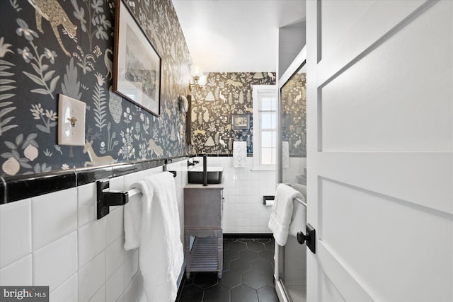 bathroom featuring tile patterned flooring and tile walls