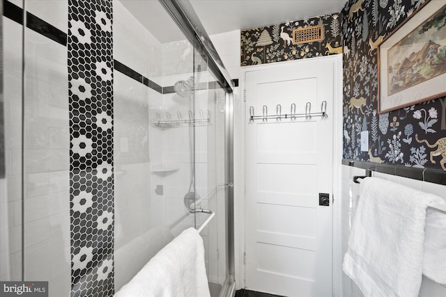 bathroom featuring a shower with door