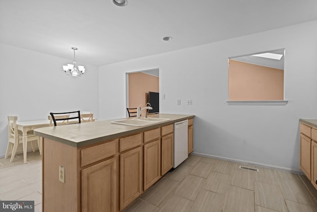 kitchen featuring dishwasher, an inviting chandelier, hanging light fixtures, and sink