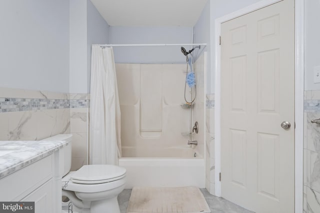 full bathroom with shower / tub combo, vanity, toilet, and tile walls