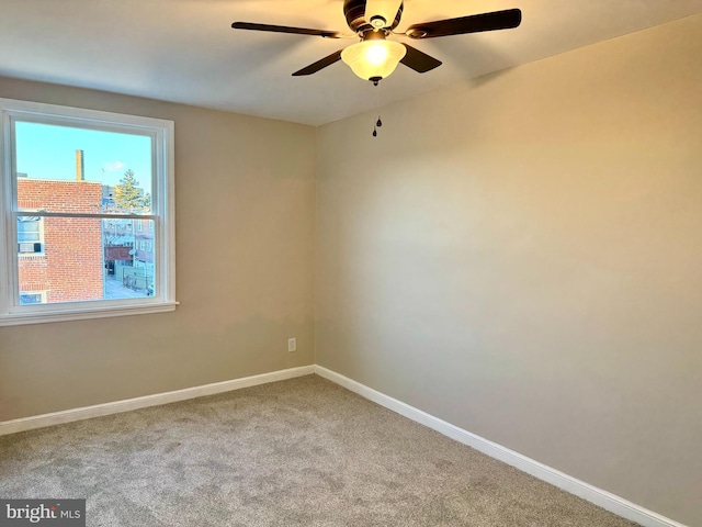 spare room featuring ceiling fan and carpet floors