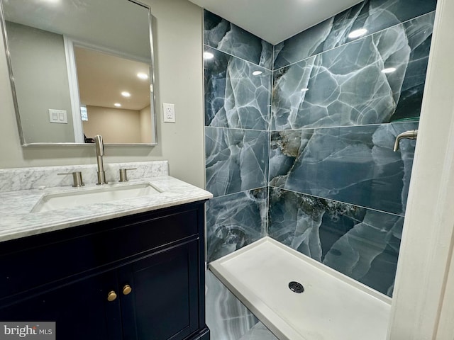 bathroom featuring vanity and tiled shower