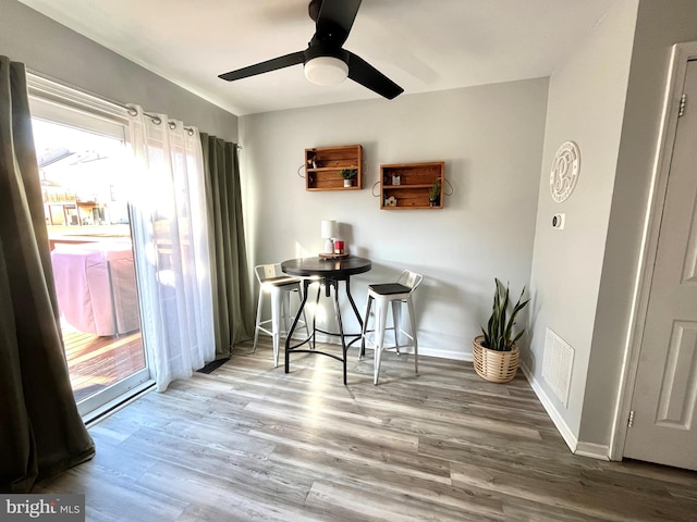 dining space featuring ceiling fan and wood-type flooring