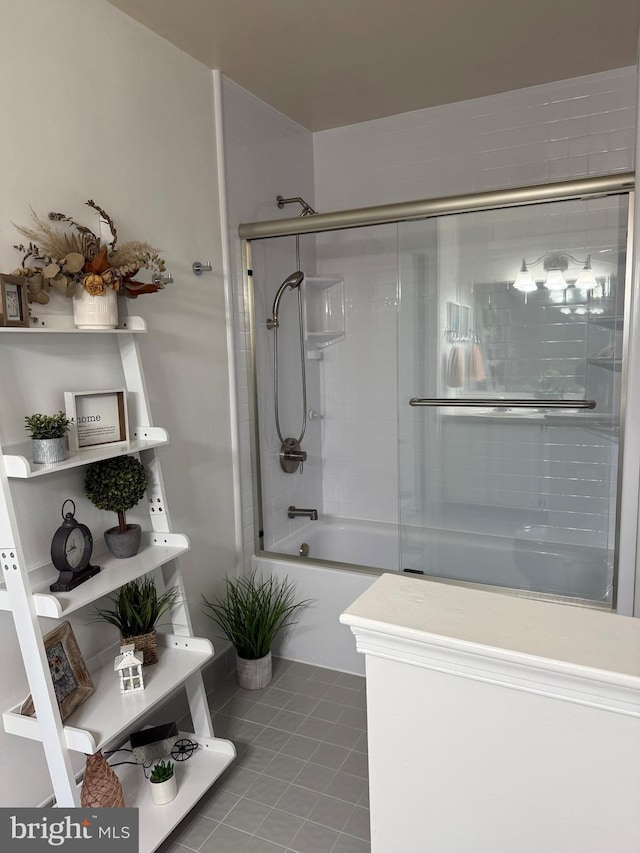 bathroom featuring tile patterned flooring and enclosed tub / shower combo