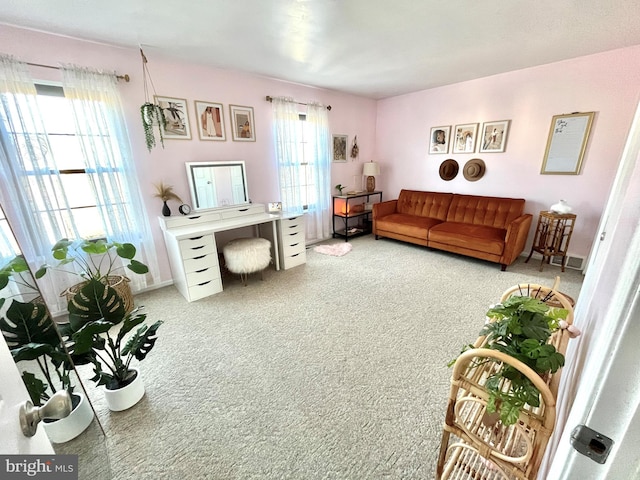 living room featuring light colored carpet and a wealth of natural light