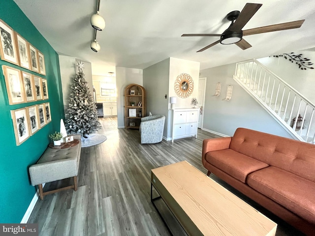 living room featuring ceiling fan and dark wood-type flooring