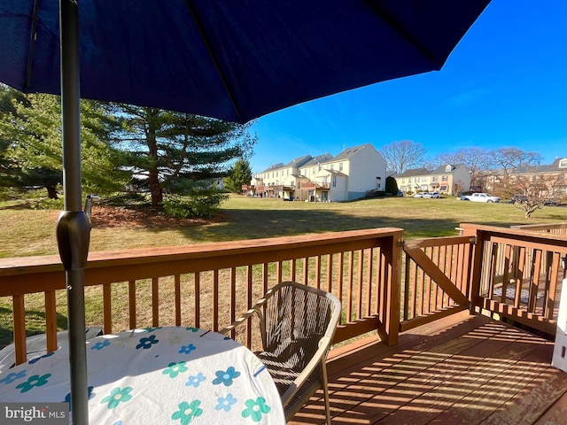 wooden deck featuring a yard