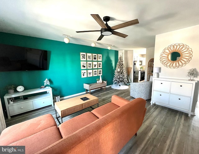 living room with dark hardwood / wood-style floors, track lighting, and ceiling fan