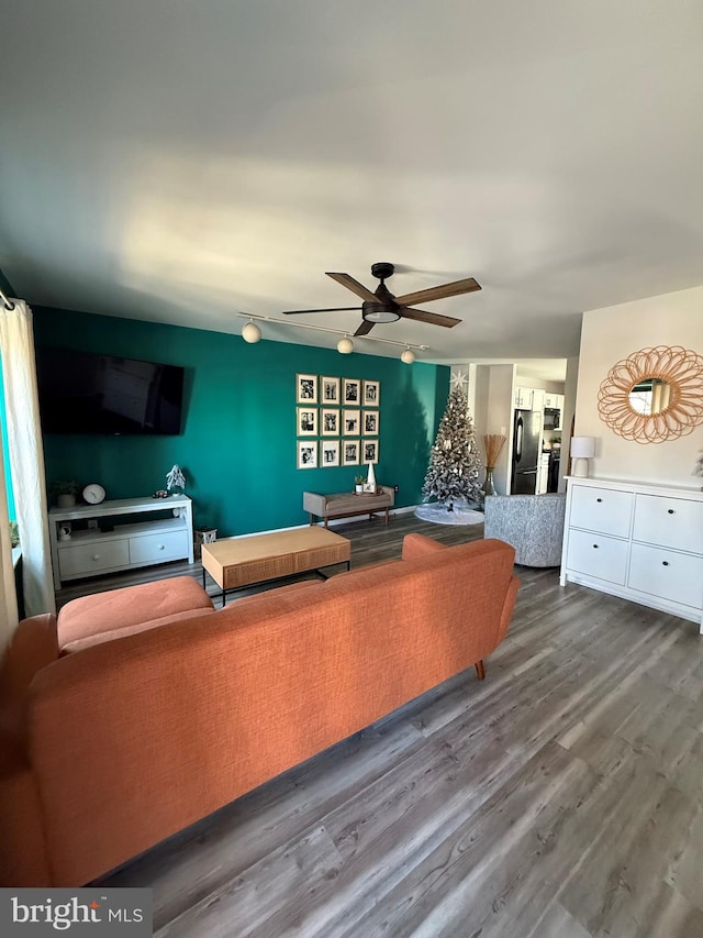 living room featuring hardwood / wood-style flooring and ceiling fan