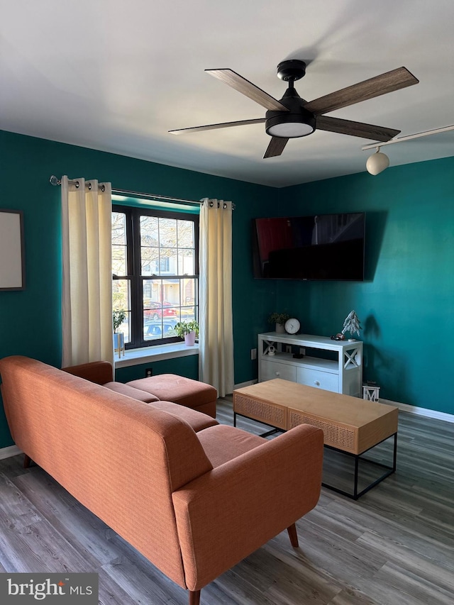 living room featuring hardwood / wood-style floors and ceiling fan