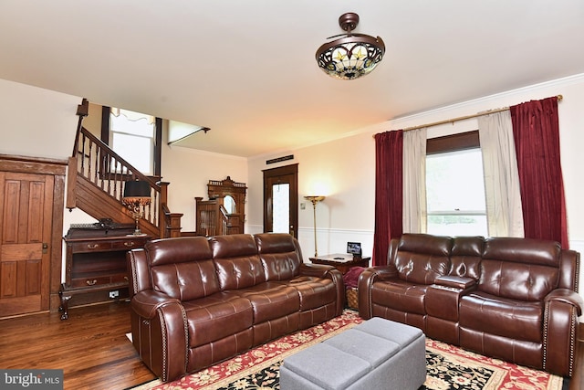 living room featuring dark hardwood / wood-style flooring and ornamental molding