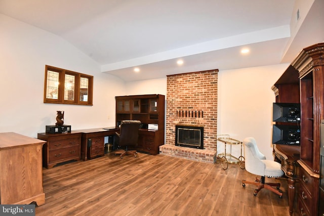115 S Summit Ave, Woodstock, VA 22664 - home office featuring vaulted ceiling, wood finished floors, built in desk, a brick fireplace, and recessed lighting