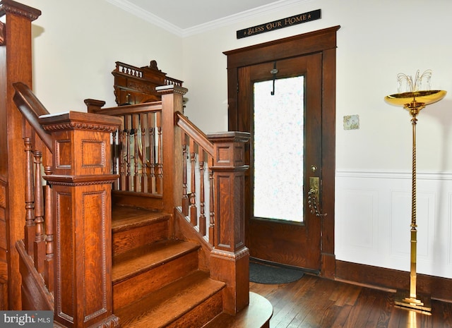 foyer with dark hardwood / wood-style floors and ornamental molding