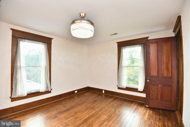 115 S Summit Ave, Woodstock, VA 22664 - spare room with dark wood-style floors and a chandelier