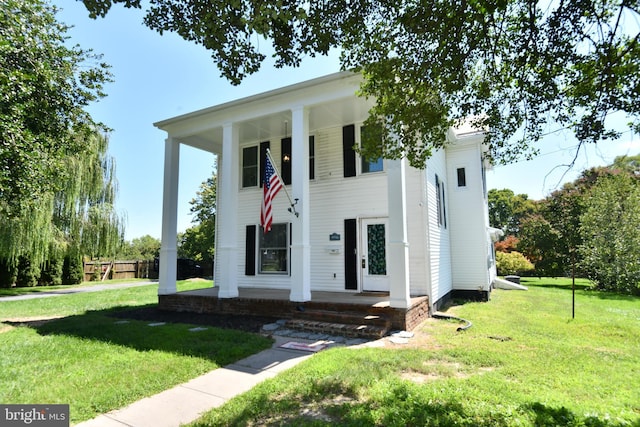 greek revival inspired property featuring a front yard and a porch