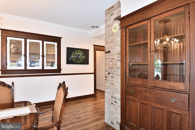 interior space featuring crown molding, dark wood-type flooring, and a chandelier