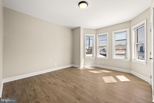 unfurnished room with light wood-type flooring