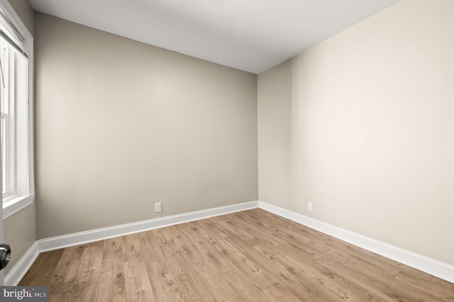 unfurnished room with light wood-type flooring