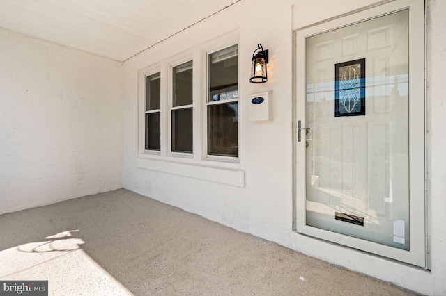 view of exterior entry featuring covered porch