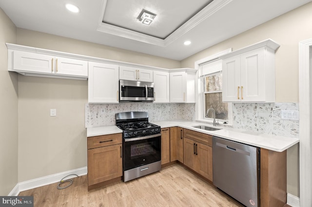 kitchen with white cabinetry, appliances with stainless steel finishes, and light hardwood / wood-style flooring