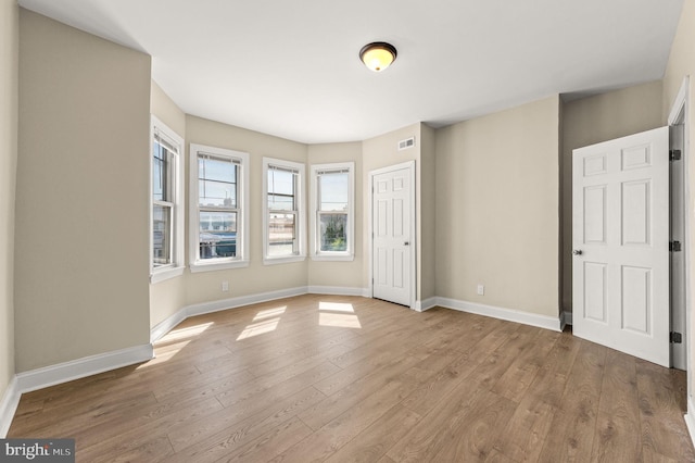 unfurnished room with light hardwood / wood-style floors