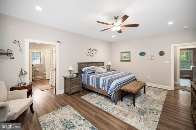 bedroom featuring ceiling fan, ensuite bathroom, and dark wood-type flooring