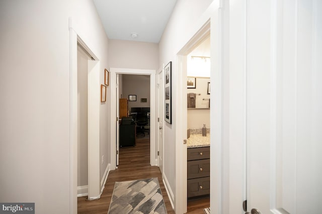 hallway with dark hardwood / wood-style flooring