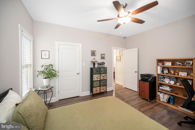 bedroom with ceiling fan and dark hardwood / wood-style floors