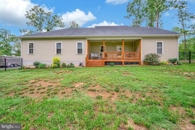 rear view of house featuring a lawn, ceiling fan, and a deck