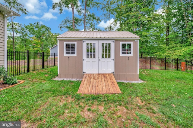 view of outbuilding with a yard