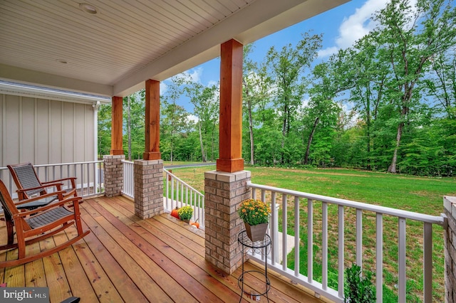 deck with covered porch and a lawn