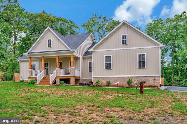 view of front of house with a front yard and a porch