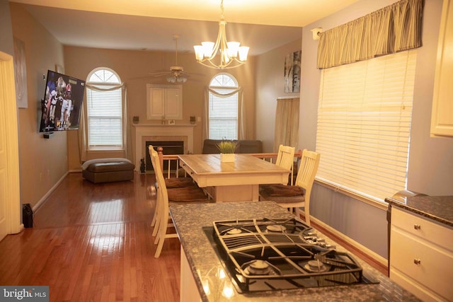 12817 Glasgow Ct, Fort Washington, MD 20744 - dining room with a ceiling fan, a chandelier, wood finished floors, and a fireplace