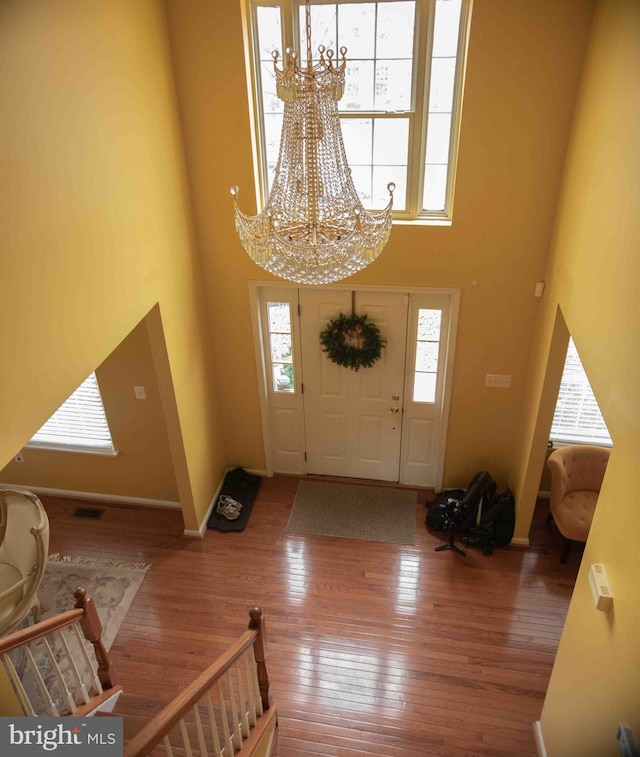 12817 Glasgow Ct, Fort Washington, MD 20744 - entryway with a chandelier, a towering ceiling, and hardwood / wood-style floors