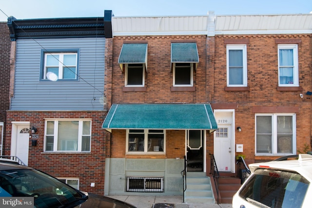 view of property featuring brick siding