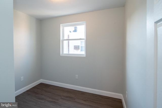 unfurnished room featuring dark hardwood / wood-style floors