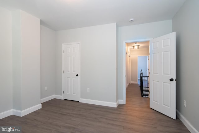 spare room with dark wood-type flooring