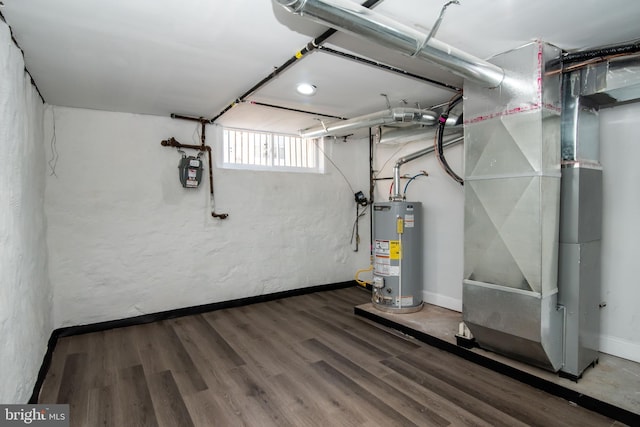 basement with heating unit, wood-type flooring, and water heater