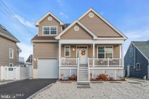 view of front of property featuring a porch and a garage