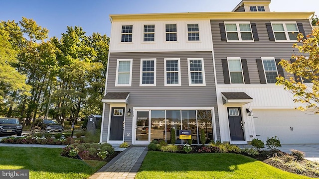 view of front of property featuring a front yard and a garage