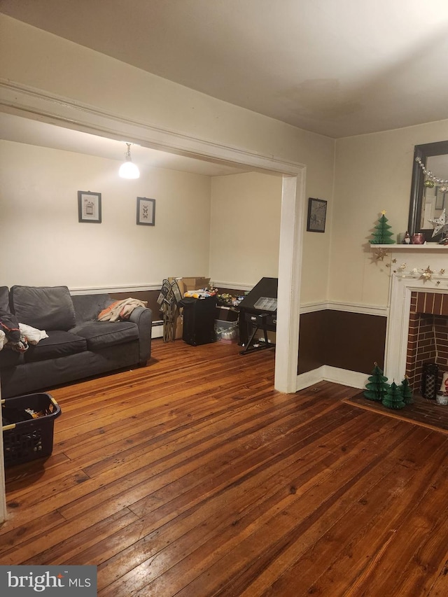 living room with hardwood / wood-style flooring and a baseboard radiator