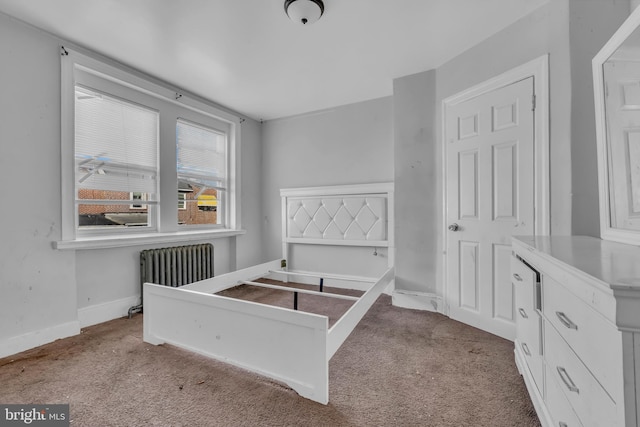 bedroom with light colored carpet and radiator heating unit